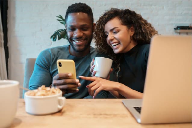 Happy couple watching smartphone