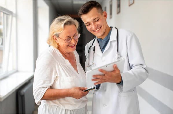 Happy doctor showing a text to old women