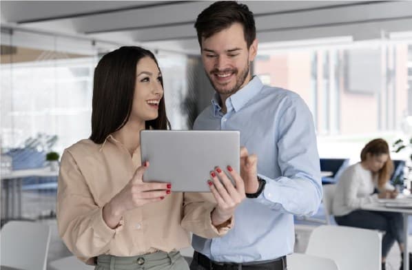 Happy women and man watching a tablet