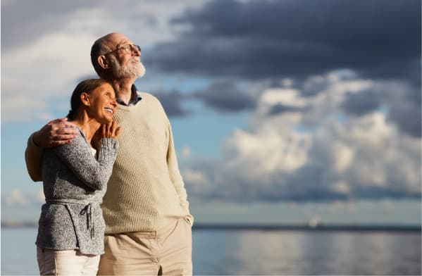 Happy old people having a hug